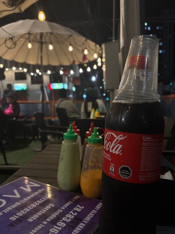 Late-night street dining under string lights near Mr. Dogs, Iquique