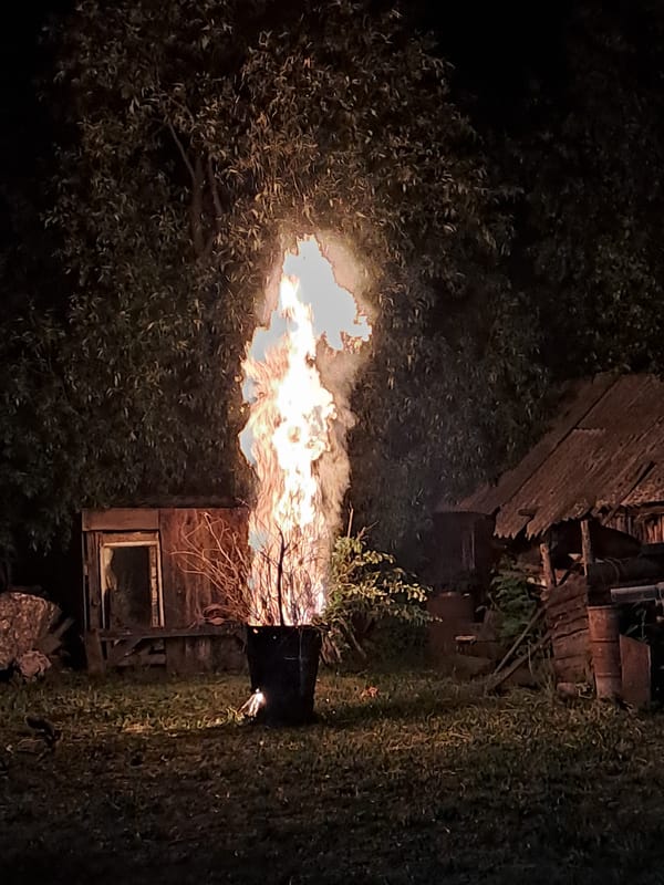 Evening bonfire burns in Полянки Russia campsite