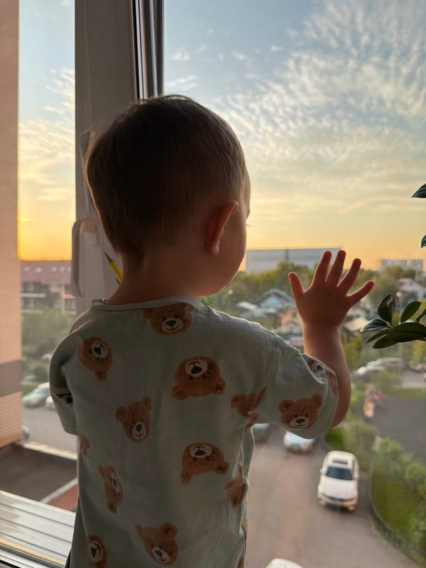 Father and toddler share sunset moment in Odintsovo home