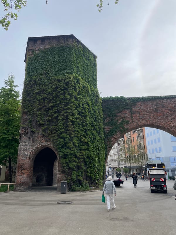 Urban documentation shows historic church tower, modern sculpture