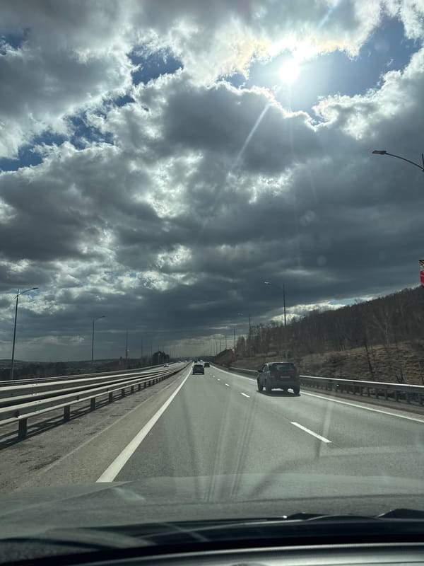 Highway travel documented near Солонцы under dramatic cloudy skies