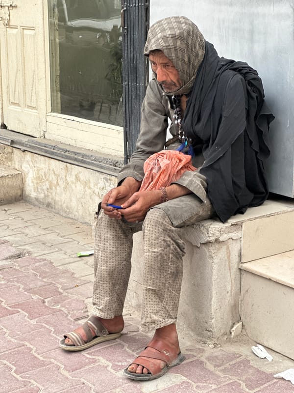 Elderly man rests outside building in Quetta, Pakistan