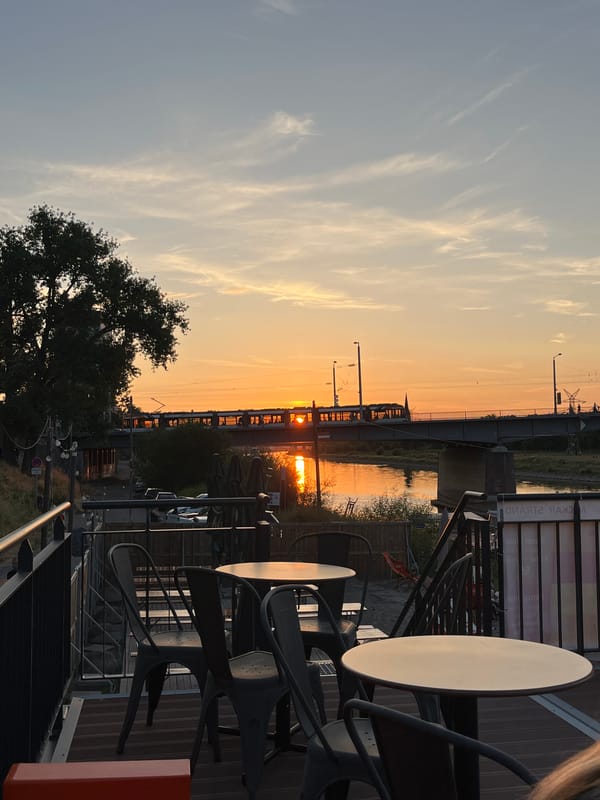 Sunset drinks at a riverside bar with bridge views