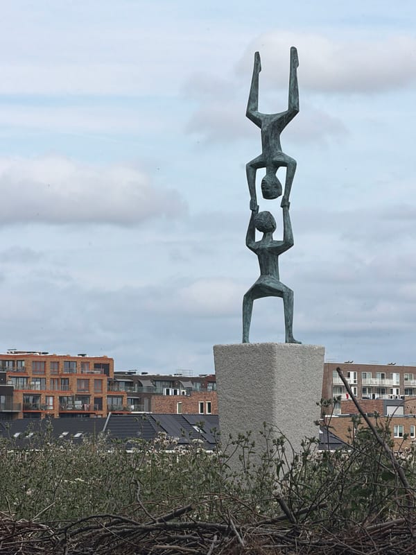 Sculptures and a wooden dock along Rijswijk waterfront