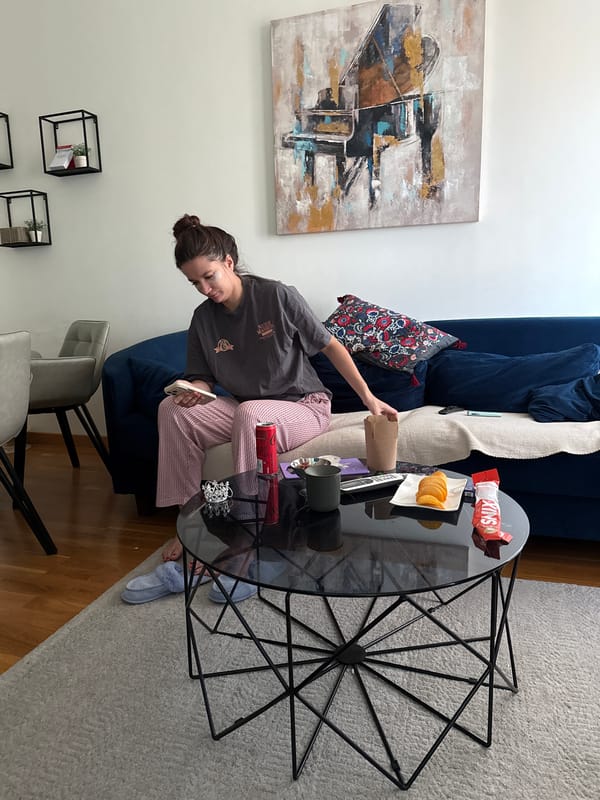 Woman and cat share quiet bedroom moment in Belgrade
