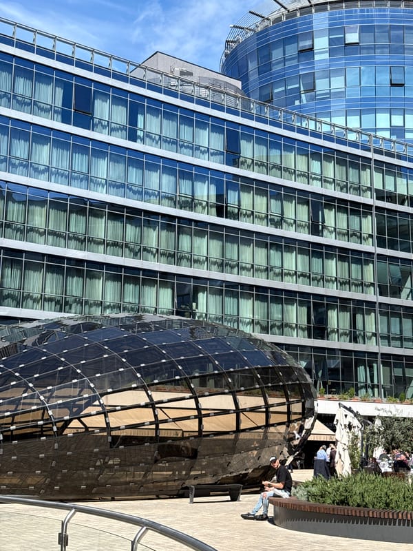 Woman takes selfies near modern architecture in Podgorica