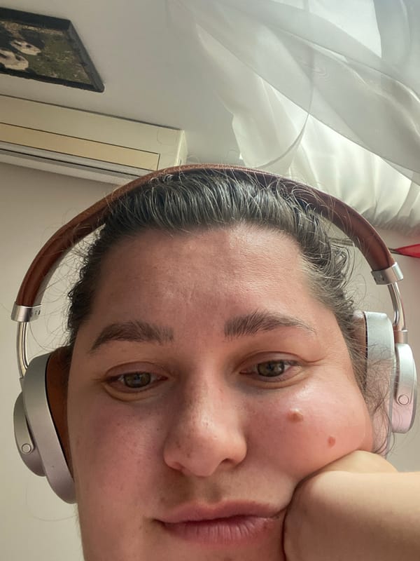 Quiet selfie moment in Perm, chin resting, headphones on