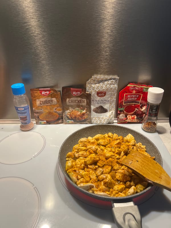 Seasoned chicken cooking on an induction stovetop in Burgas