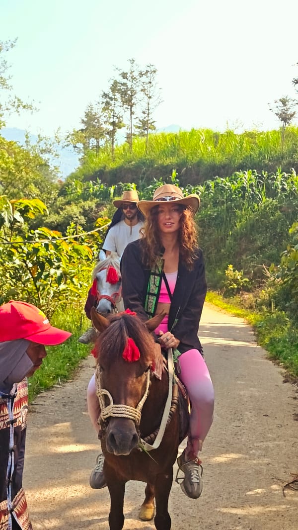 Woman rides horse in cowboy attire in northern Vietnam