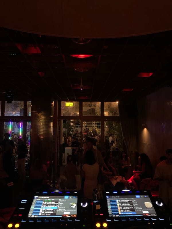 Tel Aviv nightlife: DJ booth, bar pours, and a lit courtyard
