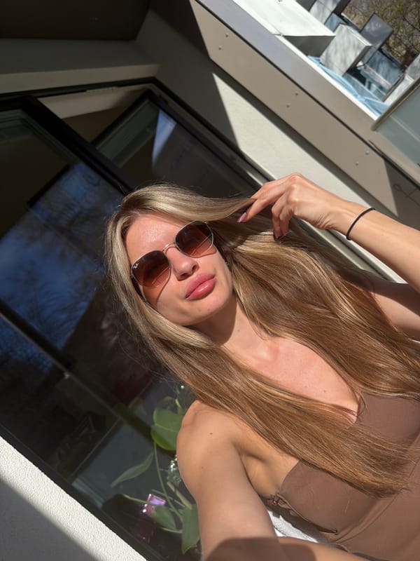 Woman takes outdoor selfies in Berlin on sunny afternoon