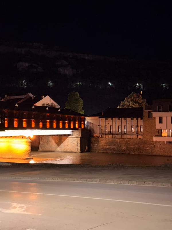 Lovech's illuminated covered bridge glows over the river at night