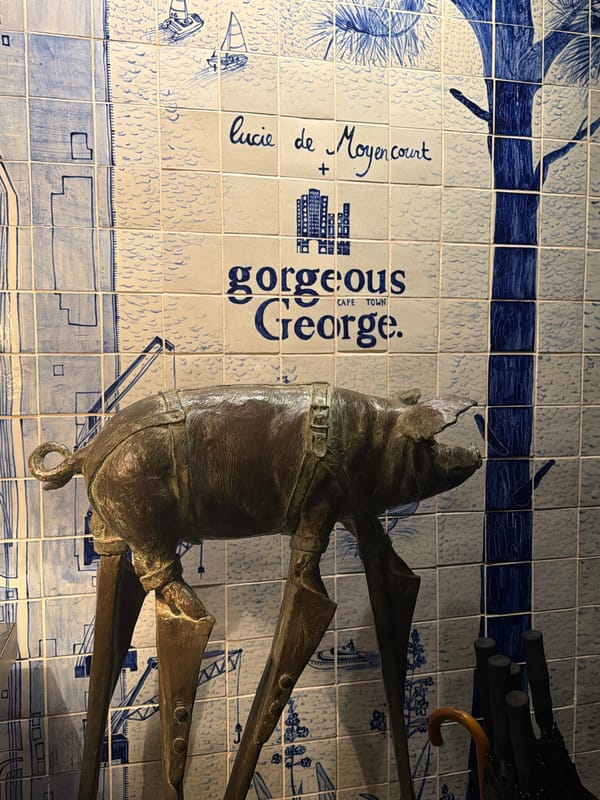 Bronze sculpture spotted against patterned tile wall in Cape Town