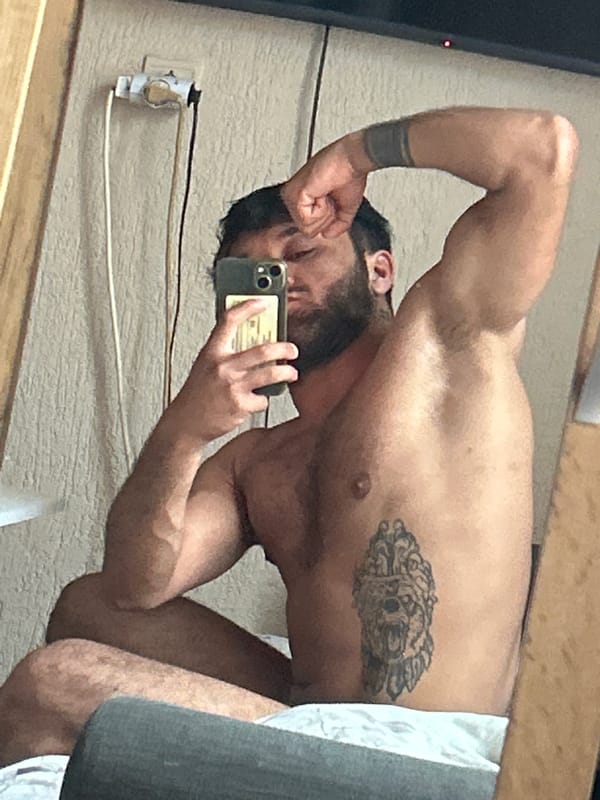 Tattooed man takes mirror selfie in Tsarevo, Bulgaria