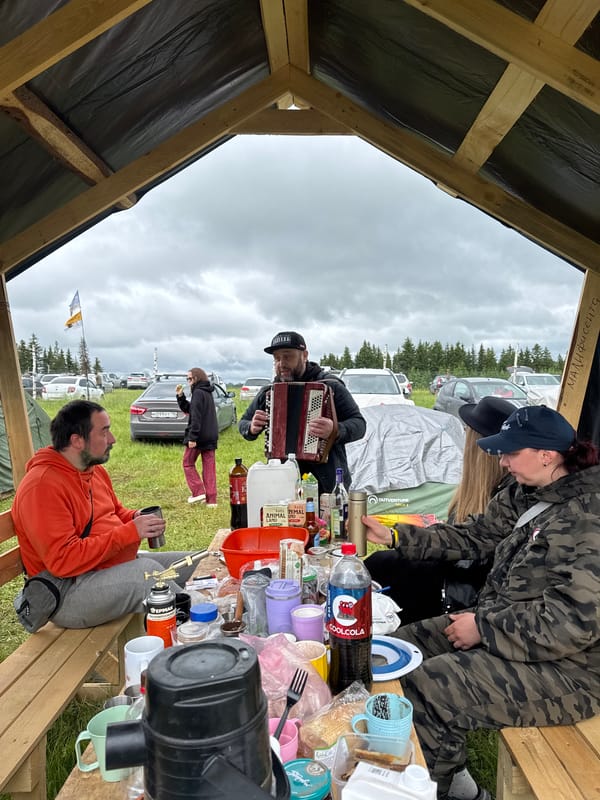Small group gathers under makeshift shelter in Lipovka, Russia