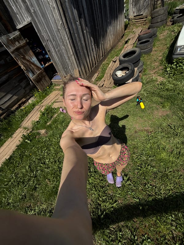 Woman takes morning selfies with mug in rural Russia