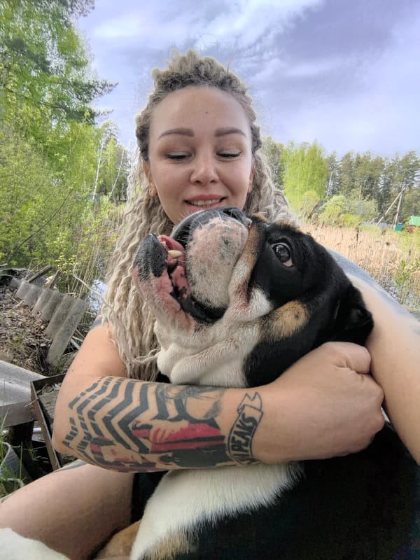 Woman and bulldog photographed on wooden platform in Russia