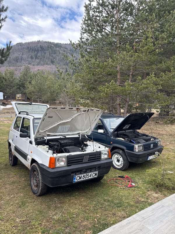 Two Fiat Pandas undergo roadside maintenance in Bulgarian village