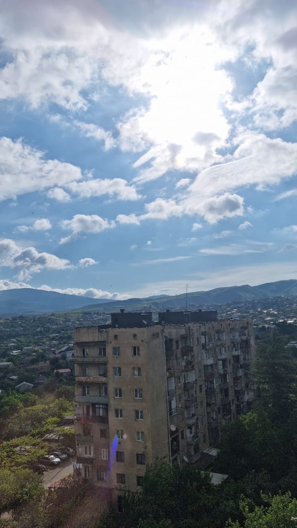 Morning coffee and rooftop views over Tbilisi's residential skyline