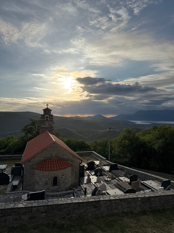 Stone church and bell tower observed at sunset in Bratešići