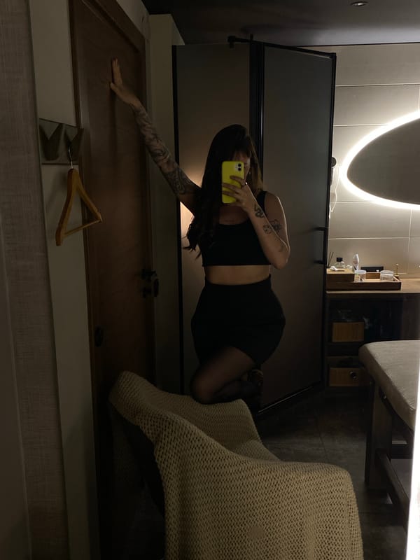 Woman takes mirror selfies with yellow phone in Votkinsk