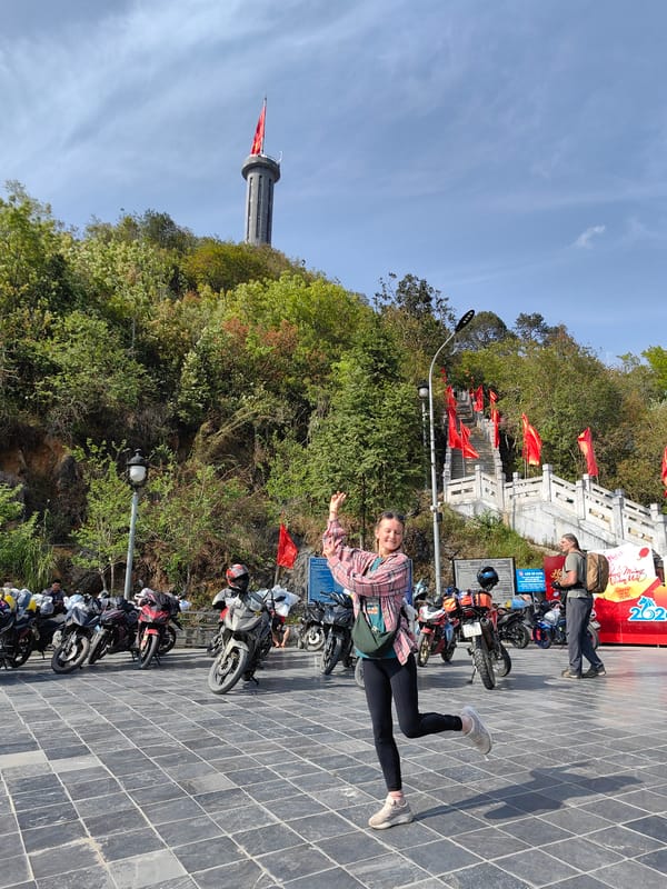 Woman poses for photo in Vietnamese commune square