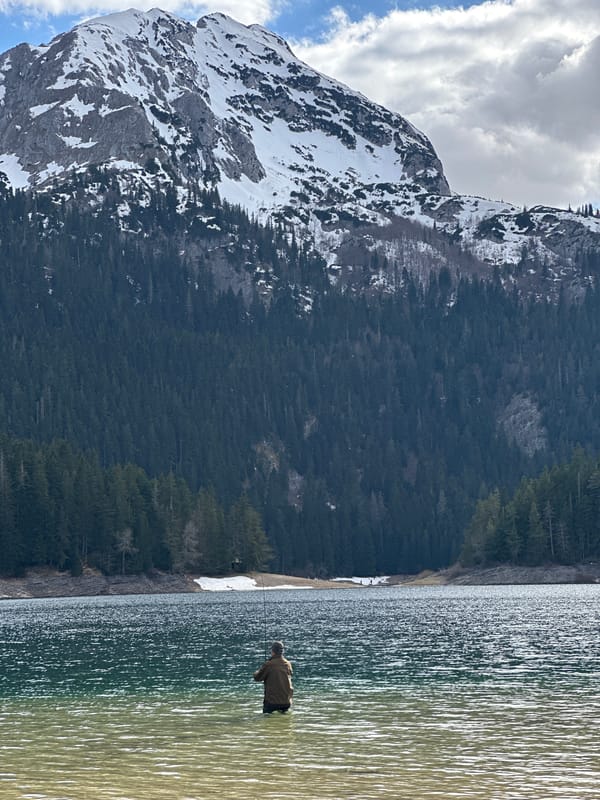 Fishermen cast lines in mountain lake near Pitomine, Montenegro