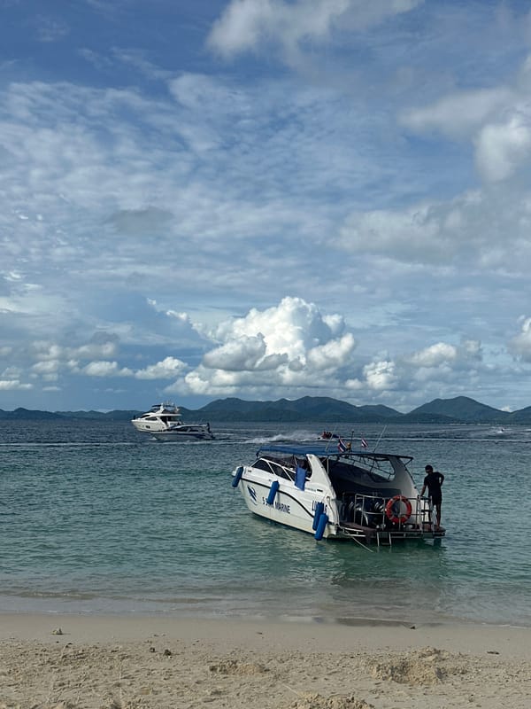 Busy morning at a Phru Nai beach, boats and Jetski Club umbrellas