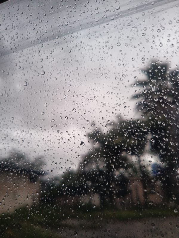 Rain obscures urban view through windows in Loja, Ecuador