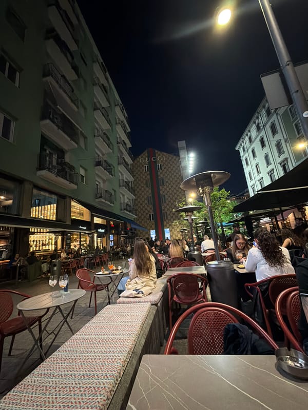 Evening outdoor dining scene captured in Milan