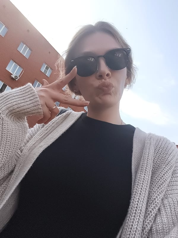 Woman takes selfies, child walks on wet Izhevsk path