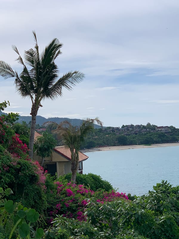 Cliffside coastal walkway in Baan Chaweng Noi, jet skis below