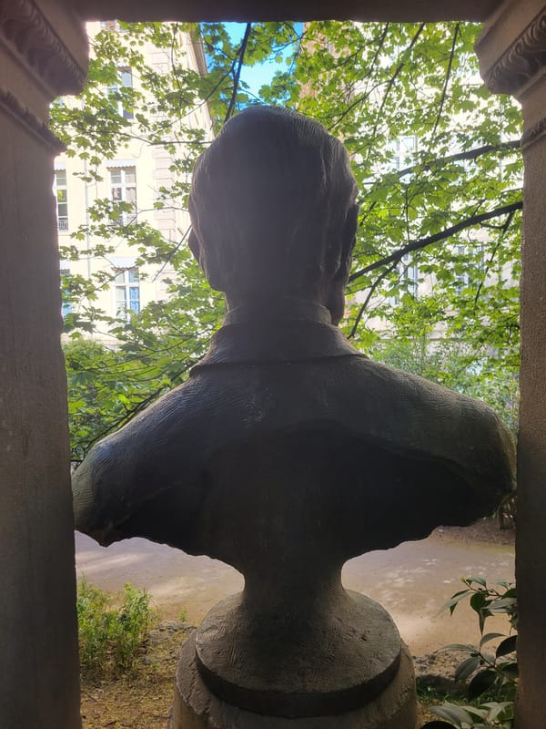 Woman visits Lyon playground near historic stone bust