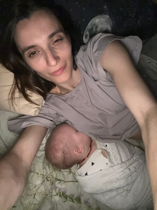 Mother and baby rest together on bed in Moscow