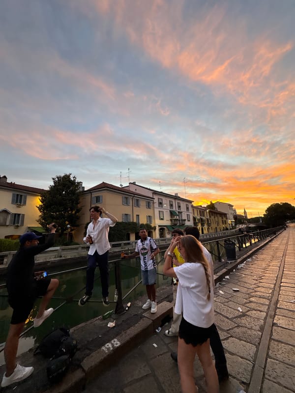 Sunset gathering on canal bridge in Milan's Navigli district