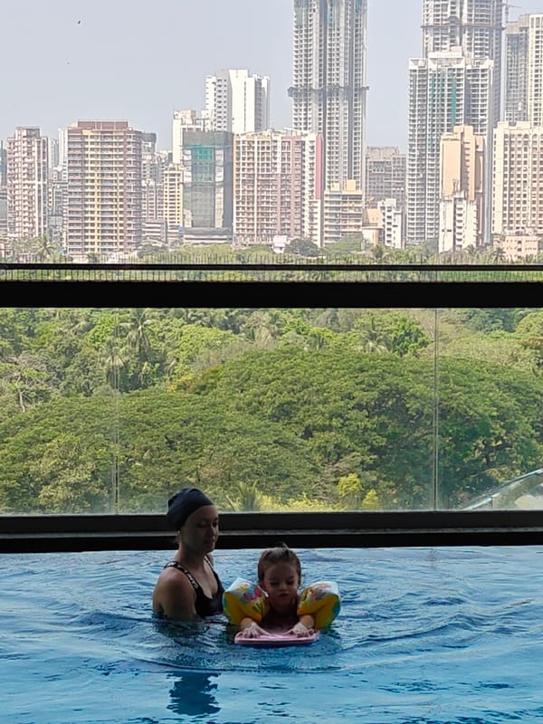 Morning scenes: children swimming, elderly cyclist in Mumbai