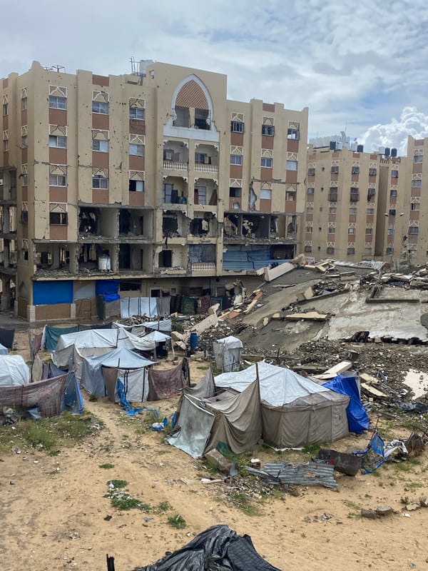 Children gather amid extensive urban destruction in Khan Yunis