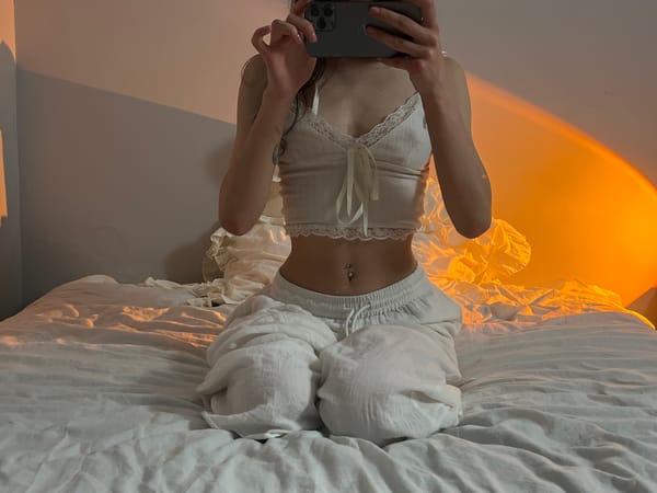 Person takes selfies on bed in Ternopil apartment