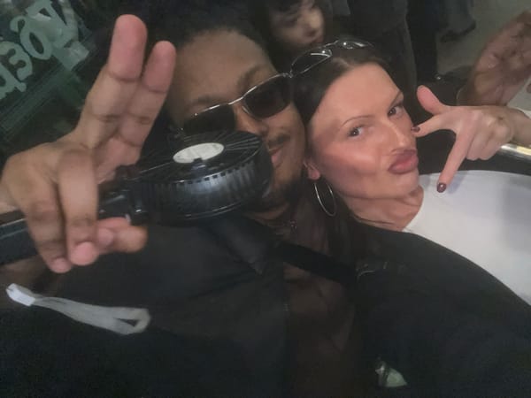 Three adults captured in dim selfie photo