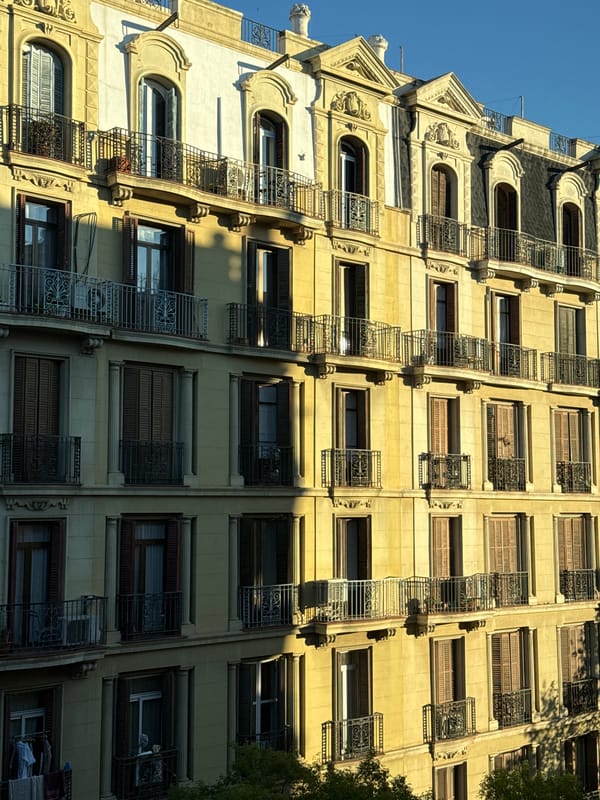 Barcelona building facade with decorative ironwork documented by witness