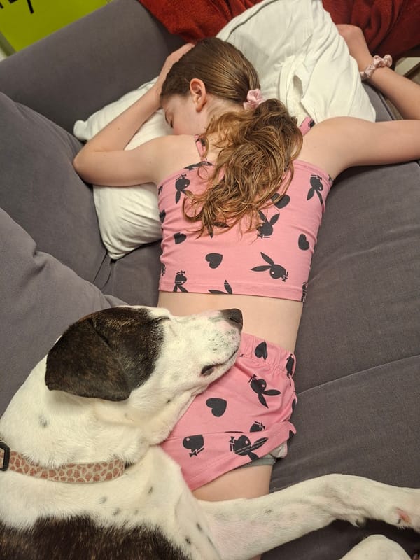 Person rests on couch in pink pajamas, Givatayim