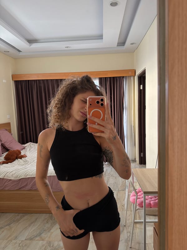 Woman Takes Playful Selfie Session in North Kuta Bedroom