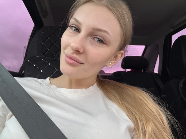 Woman photographed in car during afternoon drive in Perm