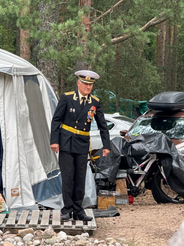 Naval-themed outdoor gathering in a Russian pine forest clearing