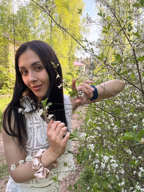Woman rests among blooming trees in Votkinsk park