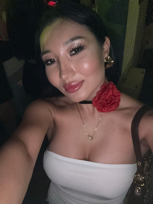 Woman takes selfie, man plays electronic music in North Kuta