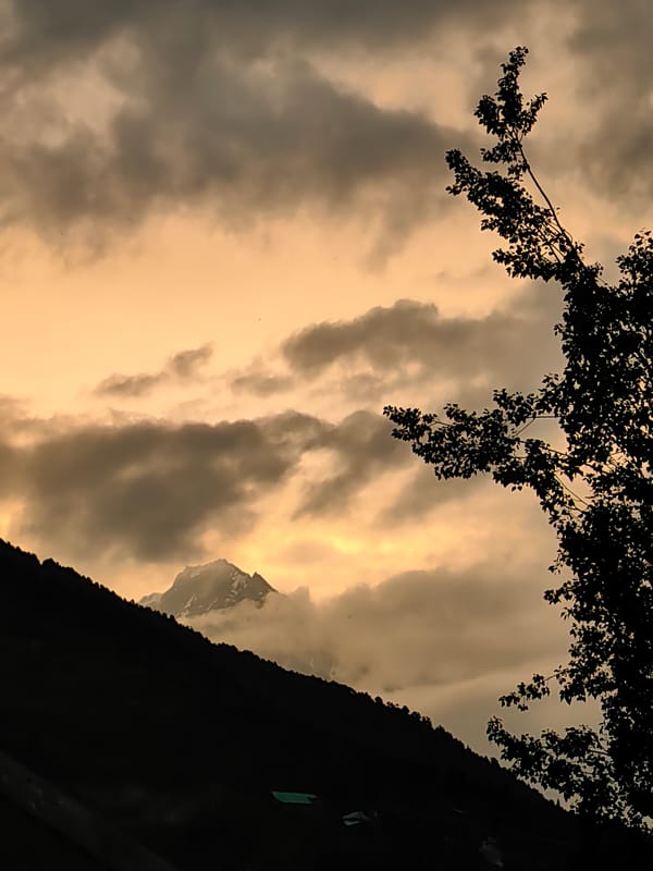 Keylong's mountain scenery at dusk, peaks and red rooftops
