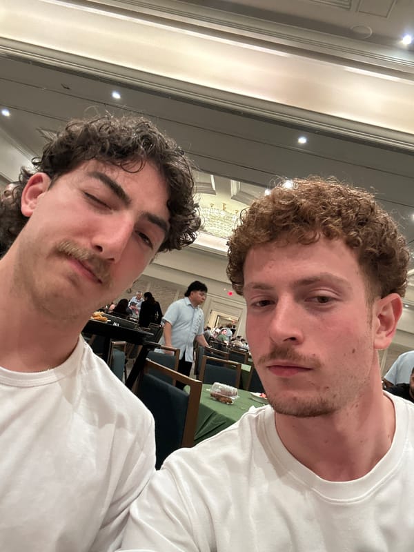 Two men take selfies indoors in Aventura