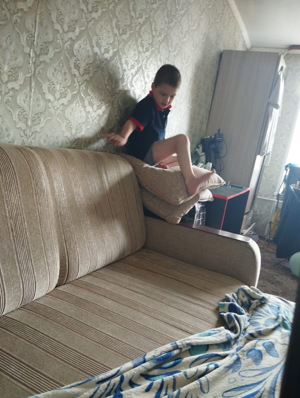 Quiet morning on the couch in Kingisepp, toy in hand