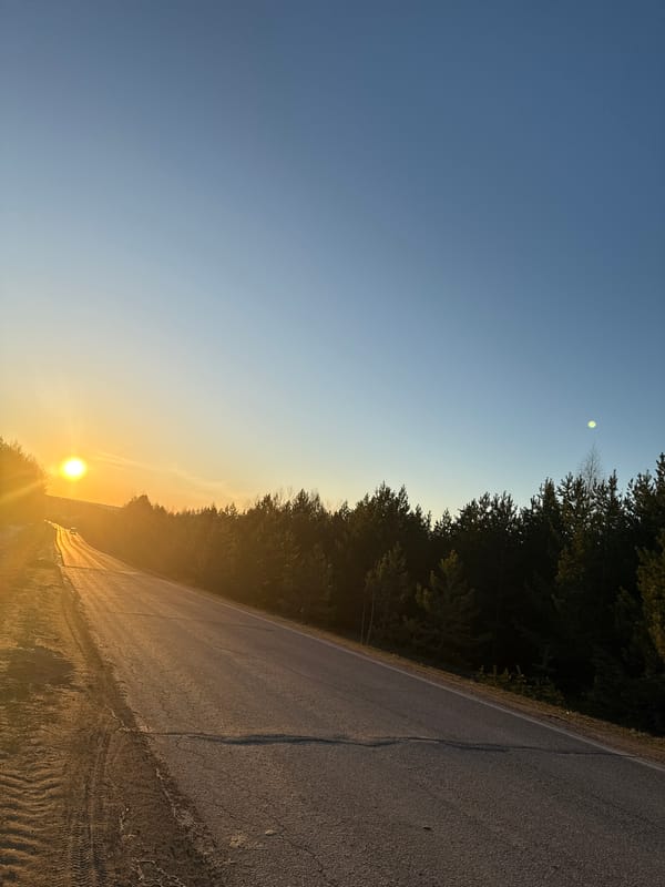 Sunset documented along wooded road in Markovo, Russia